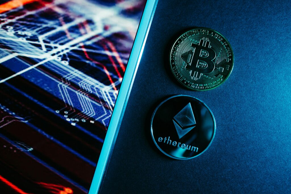 What Are NFTs and Should You Care About Them Bitcoin and Ethereum coins on a digital circuitry background symbolizing blockchain technology.